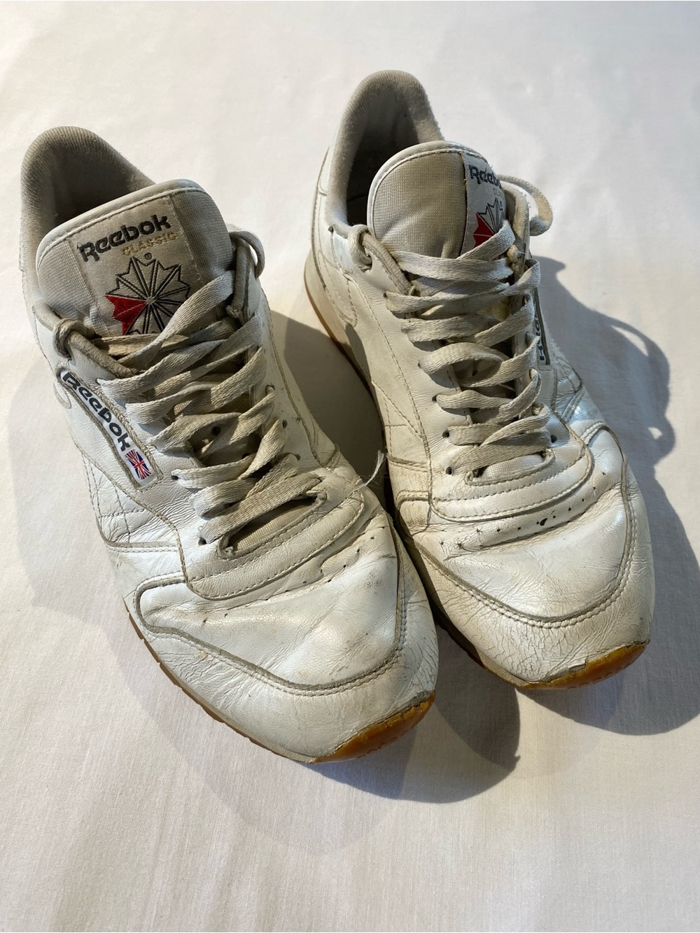 Reebok Men’s White Leather Sneakers with Red Logo Accent